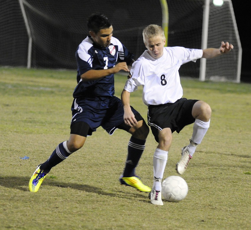 Braden Riverâ€™s Mason Bell, right, battles for possession in the second half.