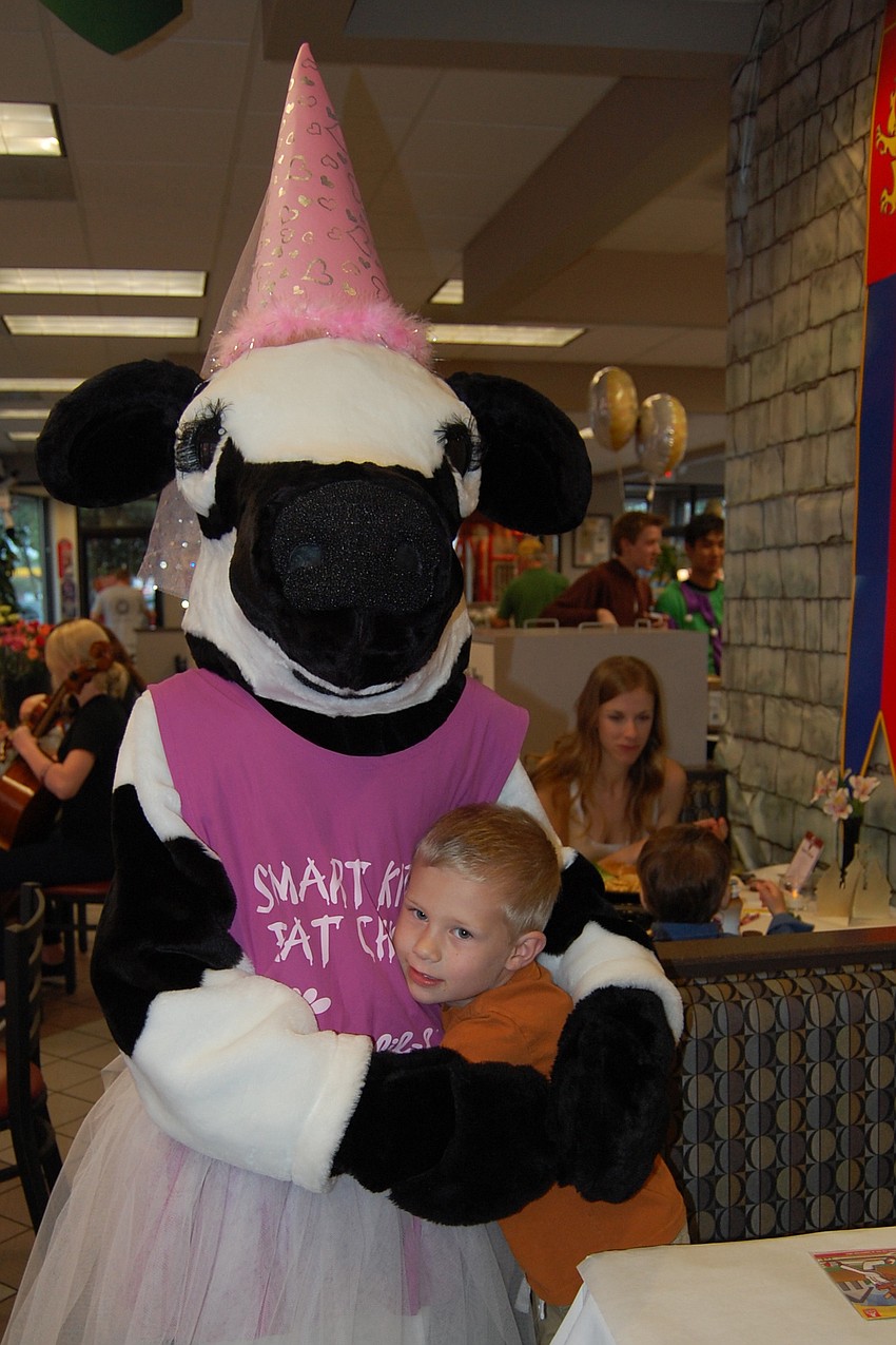 Logan Wilch got a hug from the Princess Cow after enjoying dinner with mom, Jill.