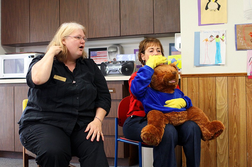 Nancy Velazquez, Janice Frankel and BeeBo do the sign for combing their hair, one of the many signs in the â€œBrand New Dayâ€ song, Tuesday, Feb. 7, during Baby Rhyme and Sign Time at Gulf Gate Library.