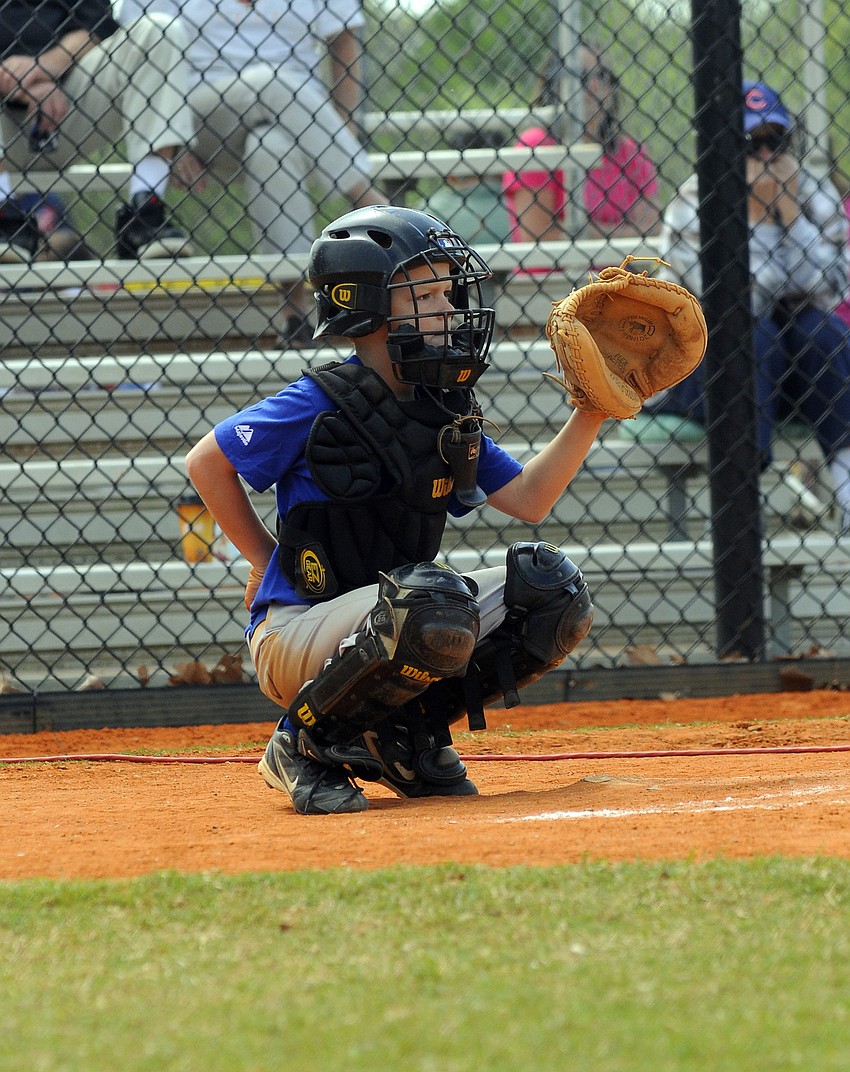 Chicago Cubs catcher Logan Grace, 8, plays machine pitch.