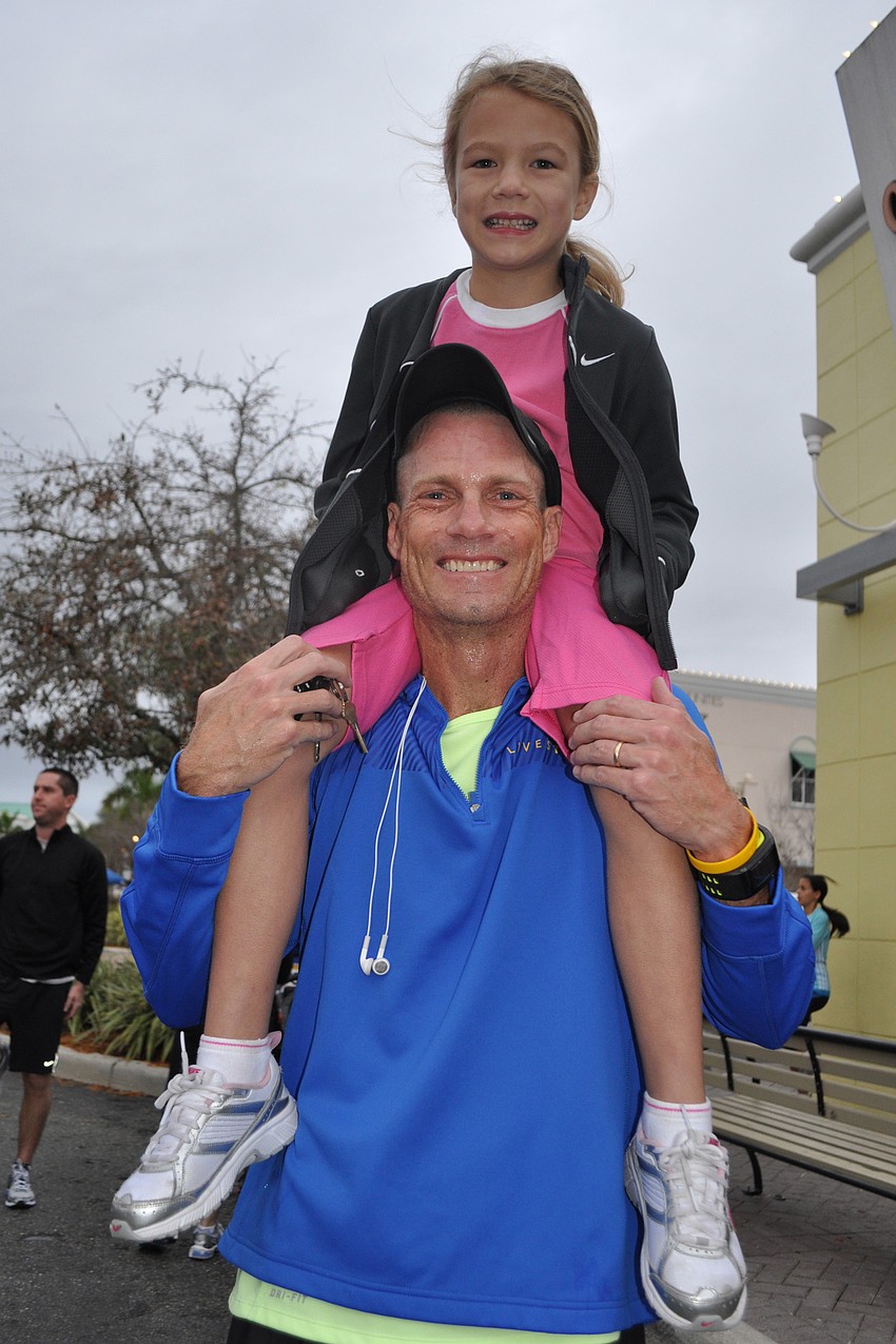 McNeal Elementary School's Cassidy McLellan got a great view from the shoulders of her father, Rick.