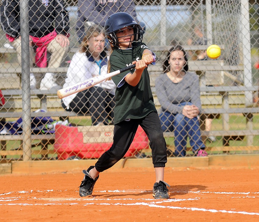 Eight-year-old Rosa Sotelo looks to make contact.