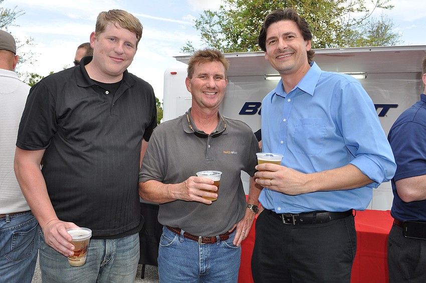 Ben Golden, left, and Todd Myrick, right, of Stewart Engineering, with James Dickason, center, of Fawley Bryant