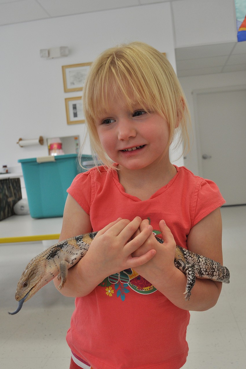 Lilli Tinnel made sure to hold Doc, the blue-tongued skink.