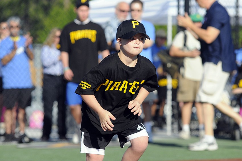 Joey Baar, 10, runs down to first base after hitting his first single of the game.