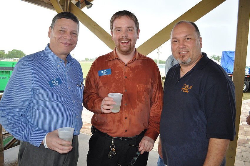 Michael Arbor and Mike Northrup, of Johnson Photo Imaging, with Charlie Halley, of 106.5 CTQ