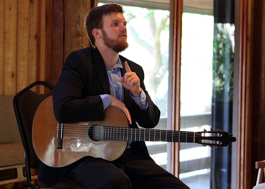 Dr. Zachary Johnson talks to the crowd about composer Isaac Albeniz, composer of two of the pieces he played on Sunday.