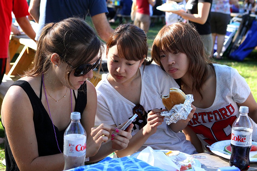 Amy Gardi, 17, uses a translator app on her iPhone to talk with Yumi Imauishi and Kanako Sawa.