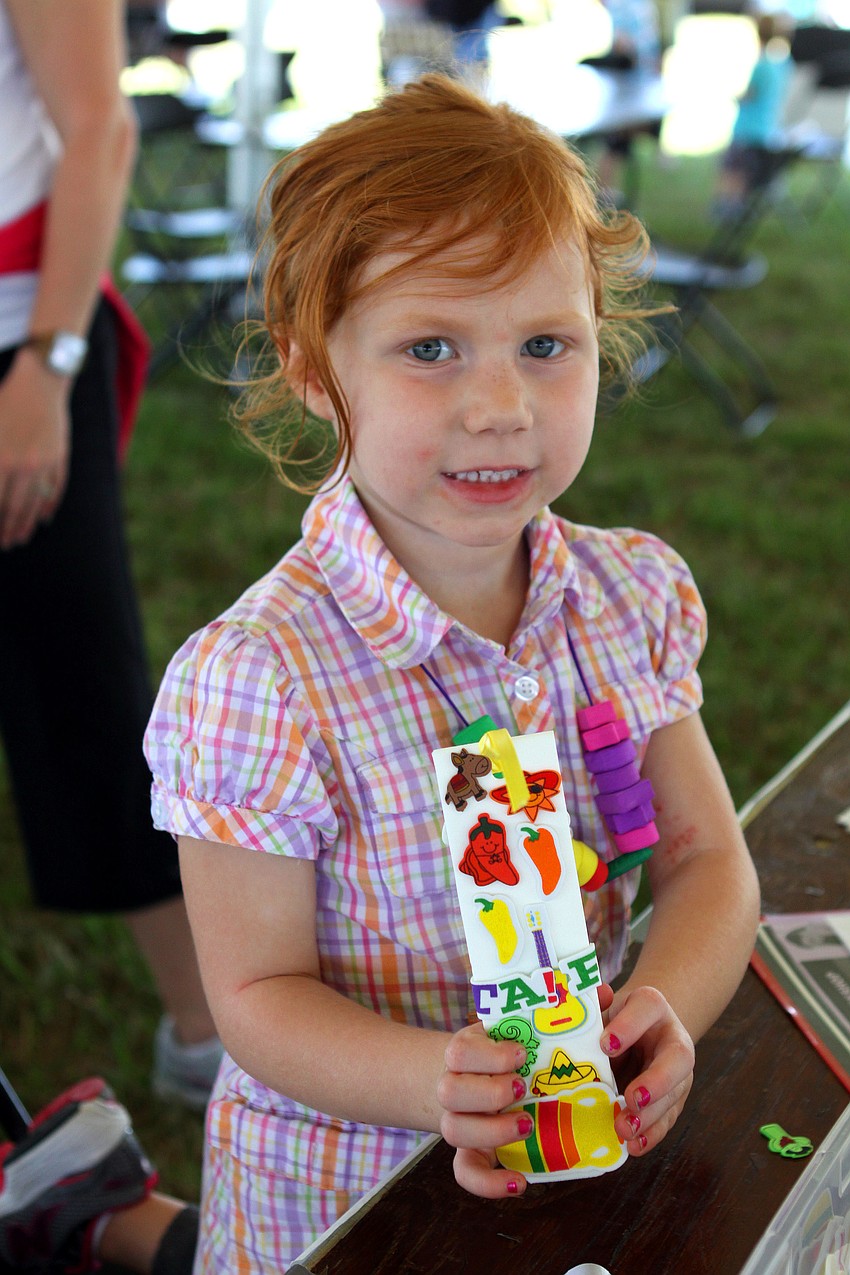 Aubri Antczak, 4, made a bookmark at the Gulf Gate Libraryâ€™s activity table at Springfest.