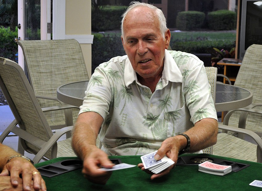 Pat Shiplett deals out the cards during a game of poker, Tuesday, March 27, at the clubhouse at Midnight Cove II.