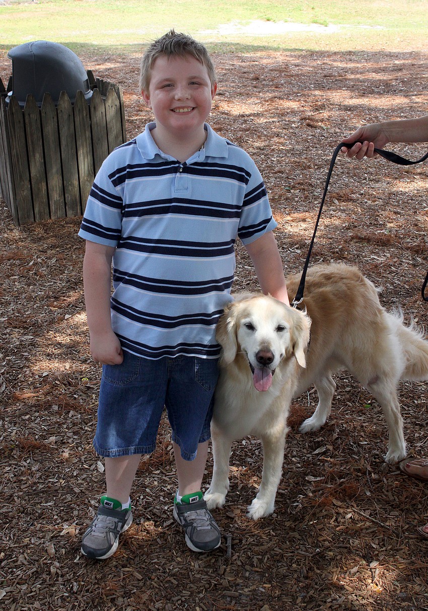 James Lawson, 8, poses with therapy dog, Mandy.