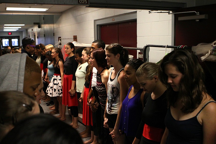 The cast of the Spring Dance Performance do an energy circle prior to taking their places backstage, Thursday, March 29.