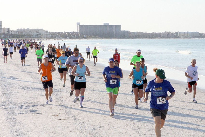 Runners in the 5K make their way towards the finish line, Saturday, April 7.