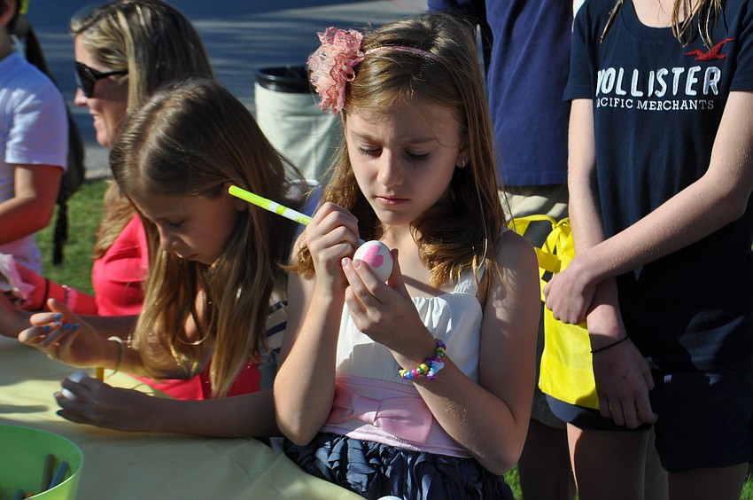 Marissa Govic decorates an egg