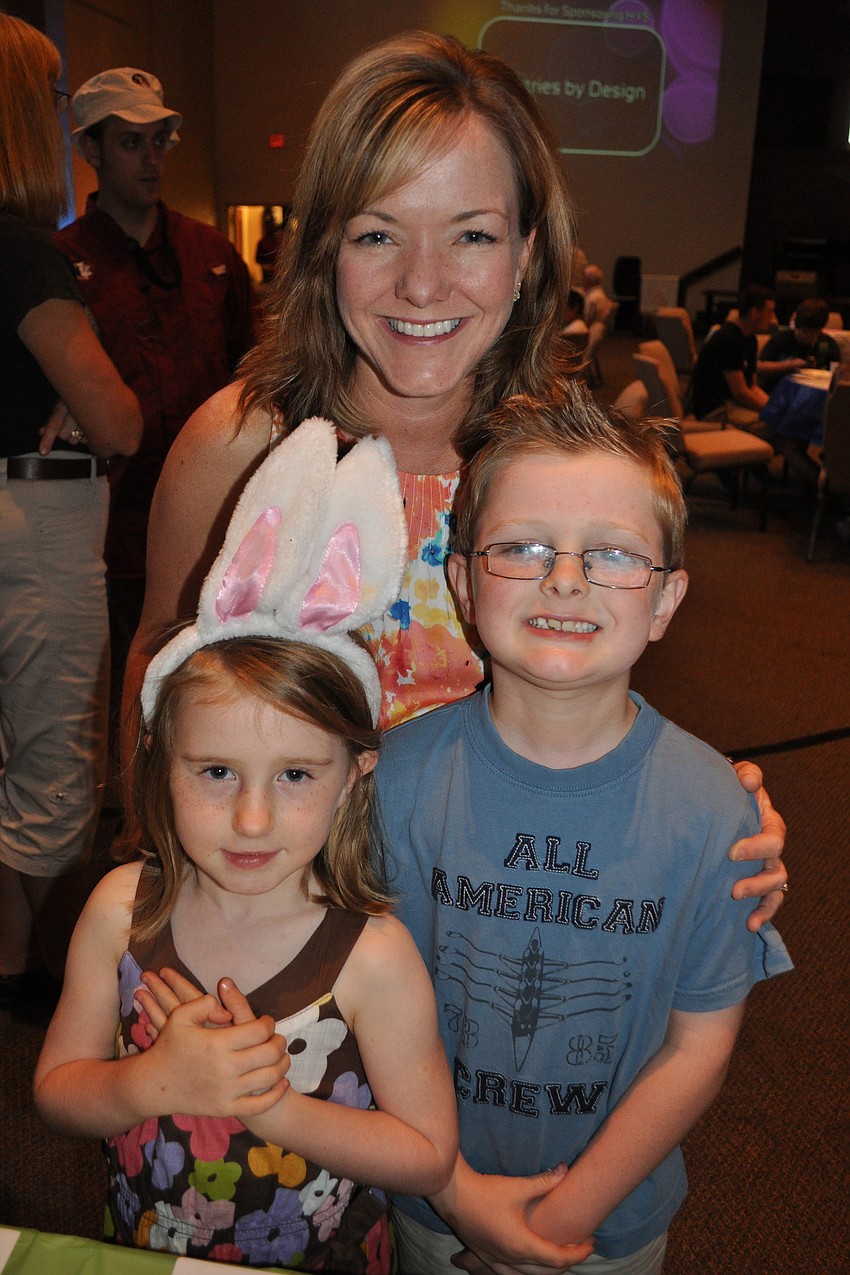 Caryn Patterson and her children, Caleigh and Jonah, checked out the silent auction tables.