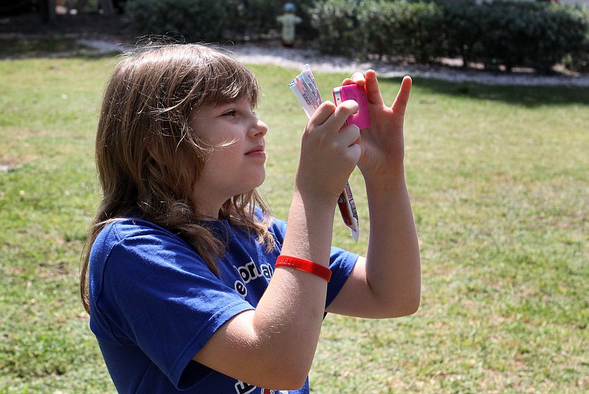 Destiny Dyle, 10, from Phillippi Shores Elementary, took photos of all of the pieces in the art exhibit so that she could always remember the field trip.
