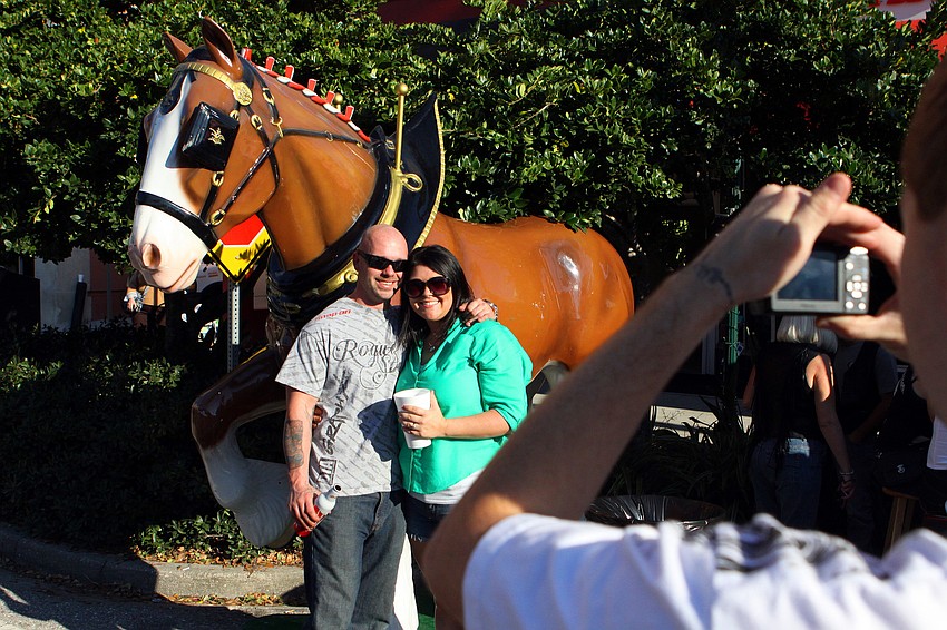 Isaiah Broach and Tondra Dunlap had their photo taken by Keith Kotecki by the Budweiser horse, Sunday, Jan. 8, during Thunder by the Bay.