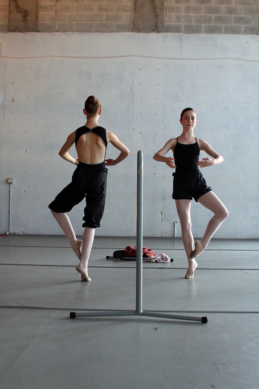Kayleigh Likens, 15, and Allison Forsyth, 15, practice balancing on pointe during a rehearsal at Studio 20.