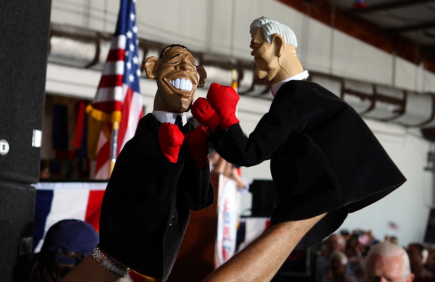 Lynn Coffin, creator of Bozo Party, had puppets of President Obama and Newt Gingrich punching one another, Tuesday, Jan. 24, at Dolphin Aviation.