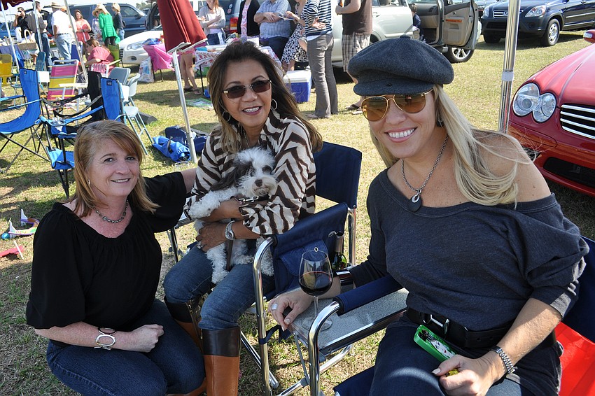 Bingo Wilson watched the polo match with Evella Feldhacker, with her dog Angel, and Tami Fox.