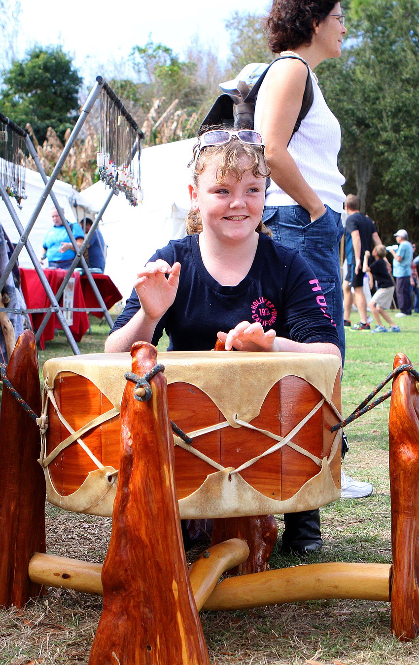 Amber Clarke, 11, has fun playing a drum, Saturday, Jan. 28, at the Fifth Annual Sarasota Indian Festival.