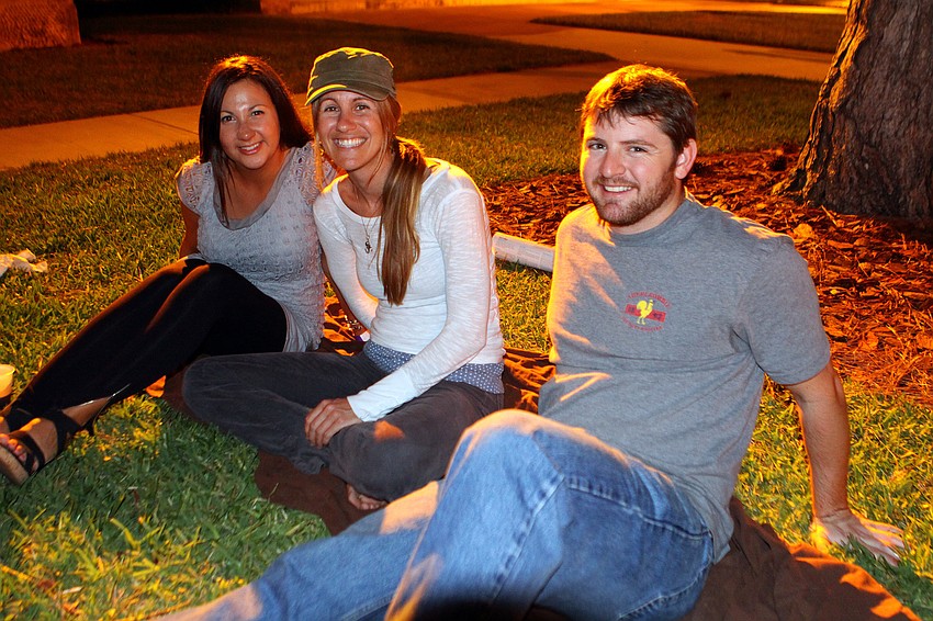 Erica Elliott, Megan Metcalf and J.D. Bevins got comfortable on a blanket in the grass and enjoyed watching the bands perform at Ringling Underground.