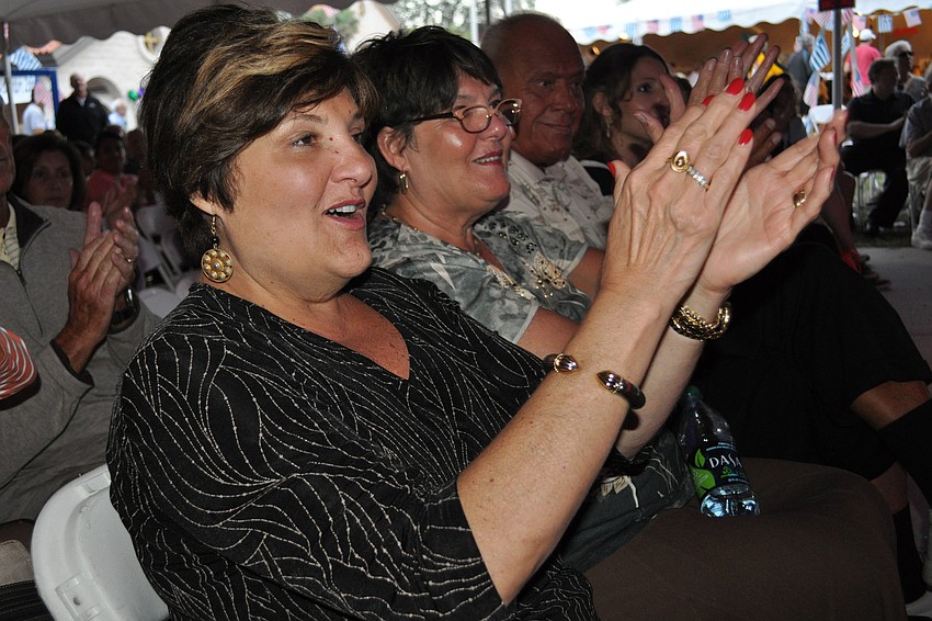 Constantina St. Armand, front, cheers as Hellenic dancers finish their routine.