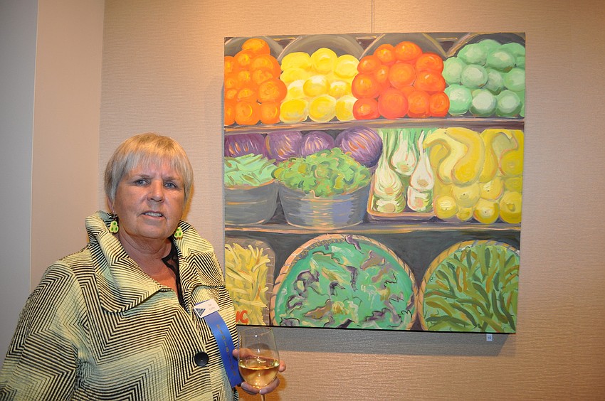 Jan Colby in front of her work â€œFresh Produceâ€ taken at Mortonâ€™s Gourmet Market