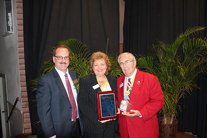Chamber President Steve Queior stands with Sharon Viner, Vice President of the Sarasota CNL Bank, who won the Chamber Partner of the Year Award and Bob Leibold, who received the Chamber Membership Master Award.