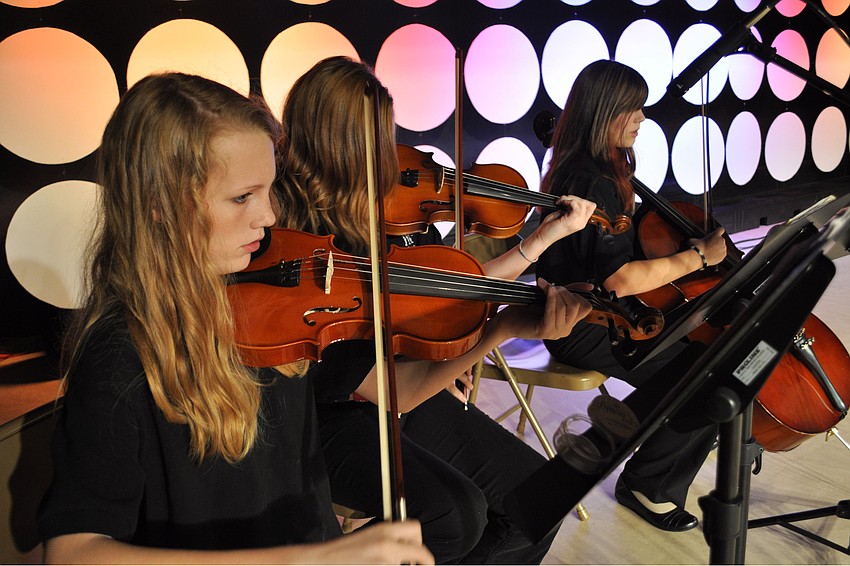 Sarah Clerkin, front, with Victoria Brown and Hailey Honaker, provided music during dinner.