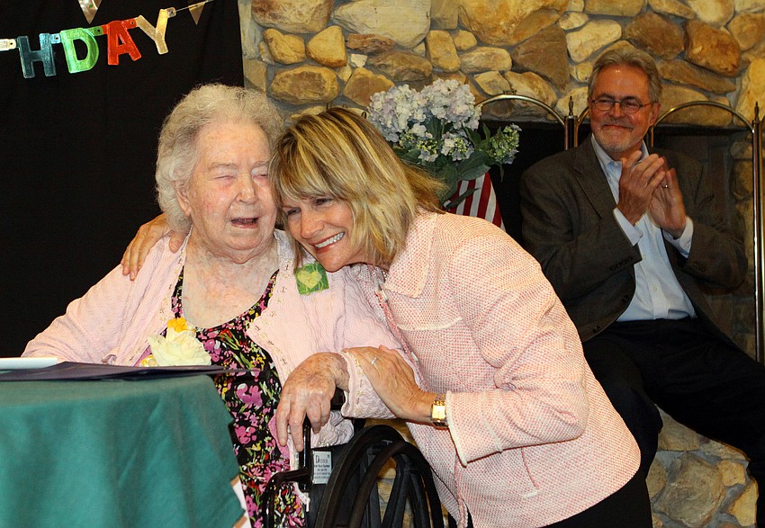 Mayor Suzanne Atwell gives birthday girl Elizabeth Delaney a hug, Monday, March 12.