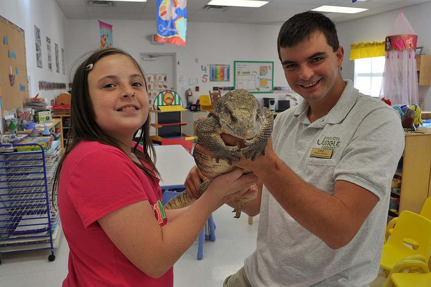 Amanda Burrus got to hold a Savannah monitor named Riddick, with the help of Sarasota Jungle Gardenâ€™s Dane Gottsch.