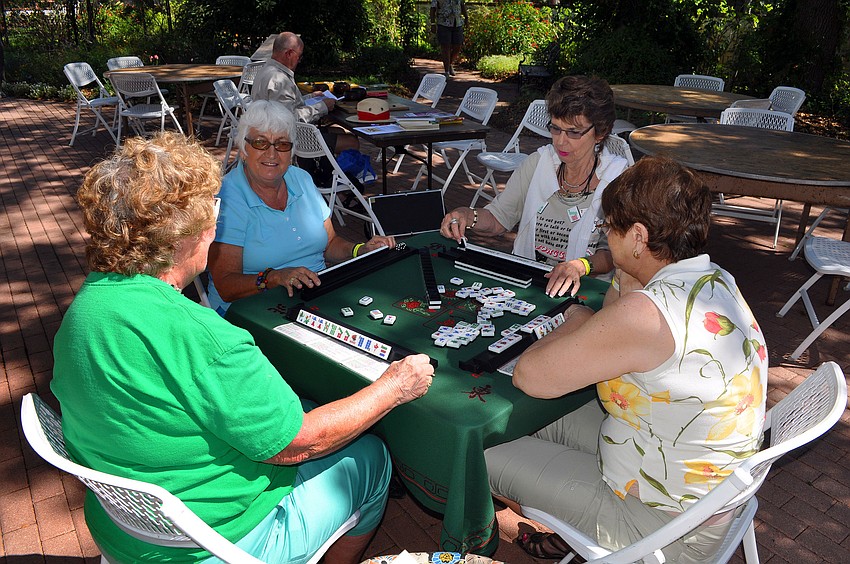 Ruth Hart, Esther Brucki, Kathy Krebser and Karen Cochran play mah jong together out in front of the mansion during the 7th annual Asian Cultural Festival.