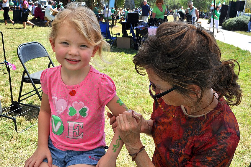 Lillian Brown, 3, had her arm painted by Patty Erwin of Pixie Painting