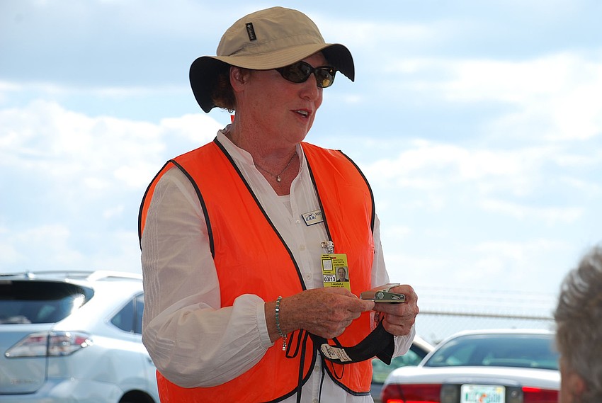 MaryLou McFate takes passengers through the safety instructions. McFate has been a member of the EAA since the 1960's.