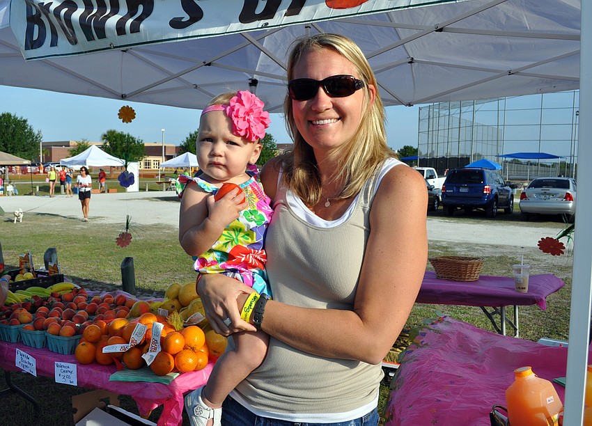 Tabby Blanchard worked the Brownâ€™s Grove farmerâ€™s market booth with her one-year-old daughter Kaylee by her side.