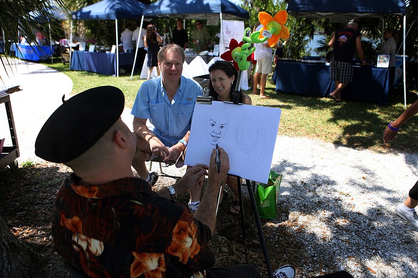 Michael White does a caricature of Jeff Polivchak and Katie Watkins, Sunday, April 1.