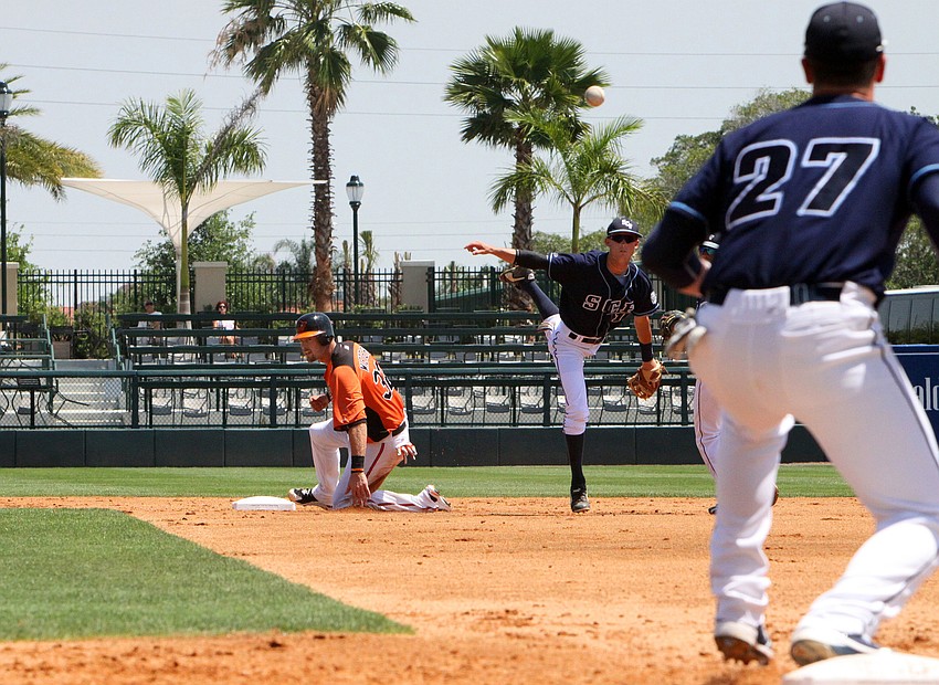 Danny Bodziak throws the ball to Kory Britton in order to make a double play against the Baltimore Orioles, Tuesday, April 3, at Ed Smith Stadium.
