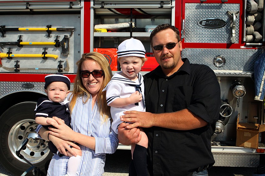 Zander Halverson, 18 mos., Kathleen Halverson, Ethan Halverson, 2, and Kyle Halverson posed together in front of the Siesta Key fire truck.