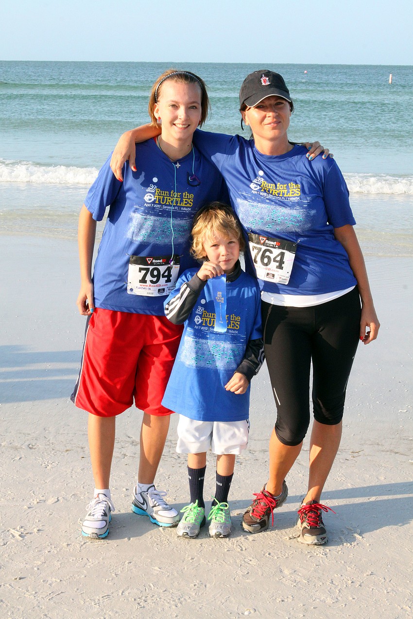 Natalia Gristlova, 16, Sebastian Gristl, 5, and Ingrid Gristlova pose together following the race, Saturday, April 7.