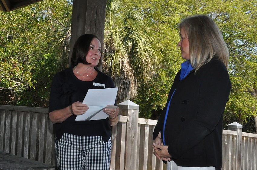 Vicki Lyons presents Dr. Dana Wetzel, program Manager at Mote Marine Laboratory with a check for $3,000