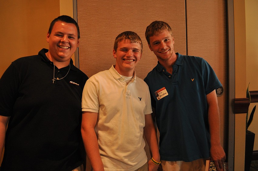Michael Powers and Ryan Burnham play football for Bayshore High. They are pictured with Ryan Burnham, one of their coaches.
