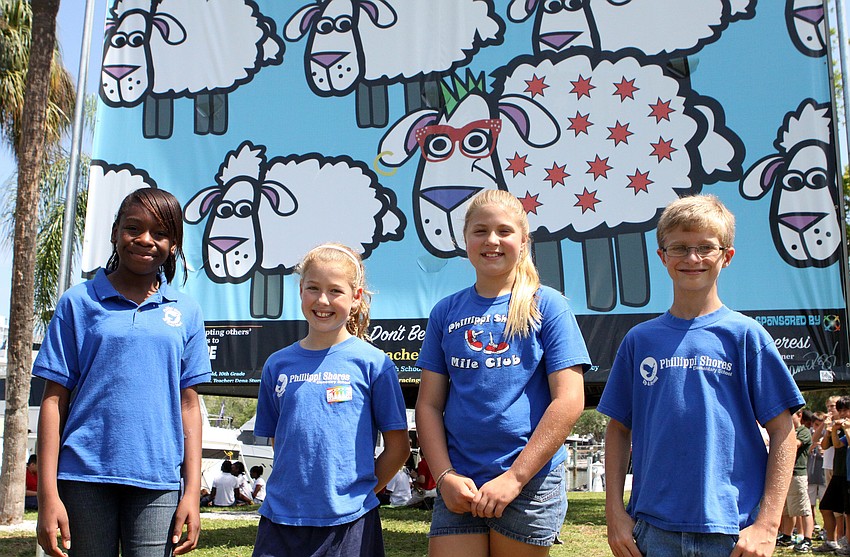 Sharon Gustave, 10, Savannah Stewart, 10, Savannah Albrecht, 10, and Gabriel King, 10, pose together in front of â€œDonâ€™t Be a Sheepâ€, Friday, April 20.