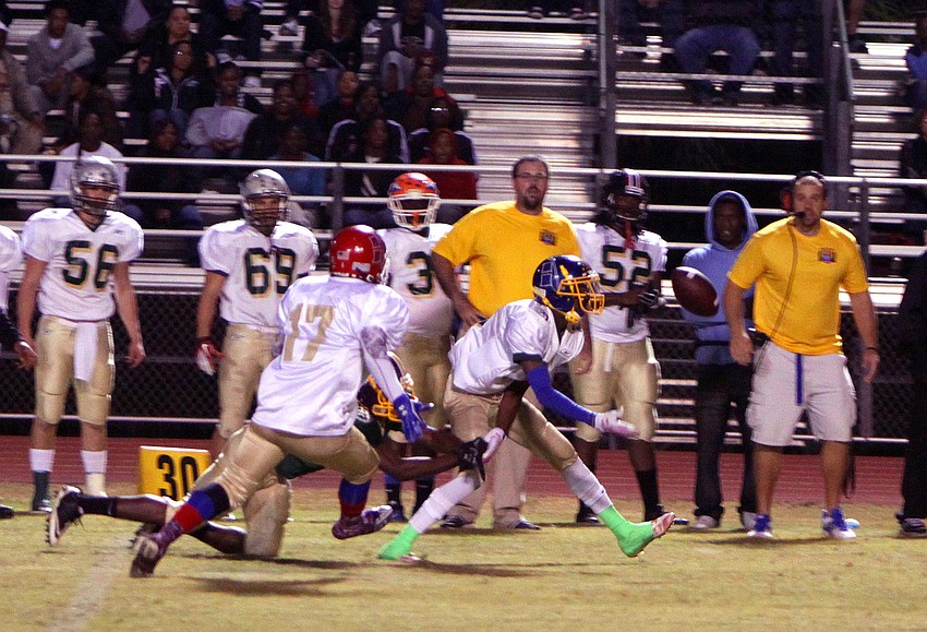 Ricky Jones, Jr., 4, tries to take down Tyderian Jenkins, 3, while Jenkins' teammate, Roshaun Goff, 17, runs in to help.