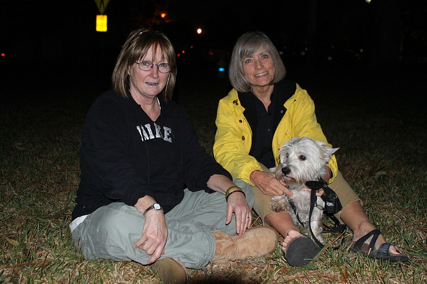 Vicki Thomas, Kathy Ogilvie and Tobey enjoy listening to Cheryl Losey play the harp during 