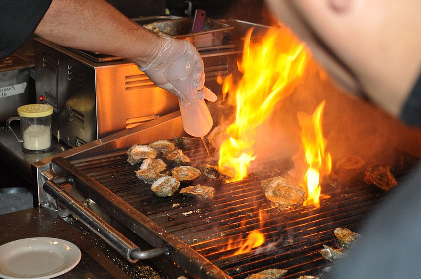 Cooks prepare oysters for the Half Shell Oyster House's opening party on Friday, Jan. 6.