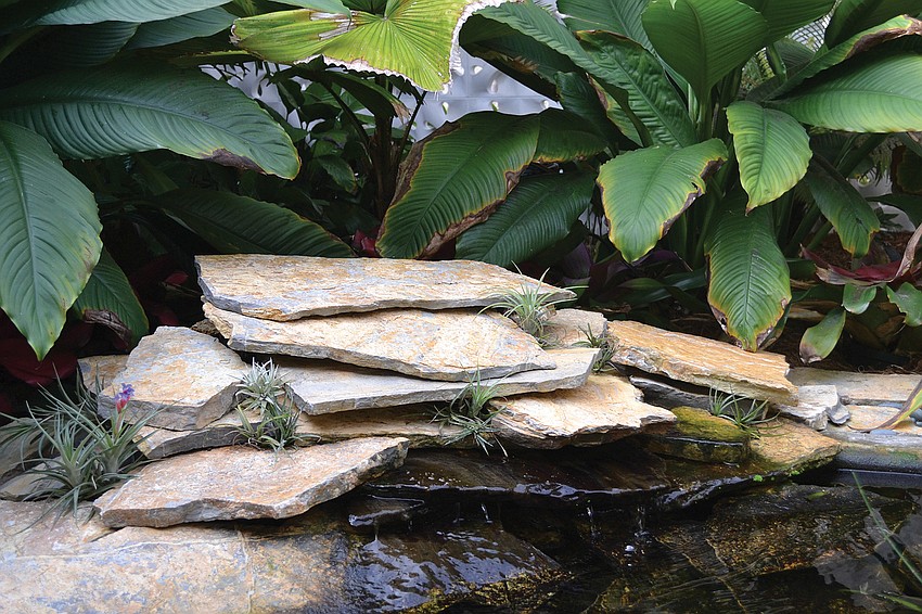 This waterfall that flows into the courtyard goldfish pond was built specifically for the garden.