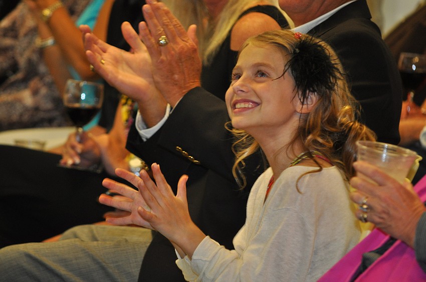 Gianna Sparks watches her dad, Dave, walk the runway