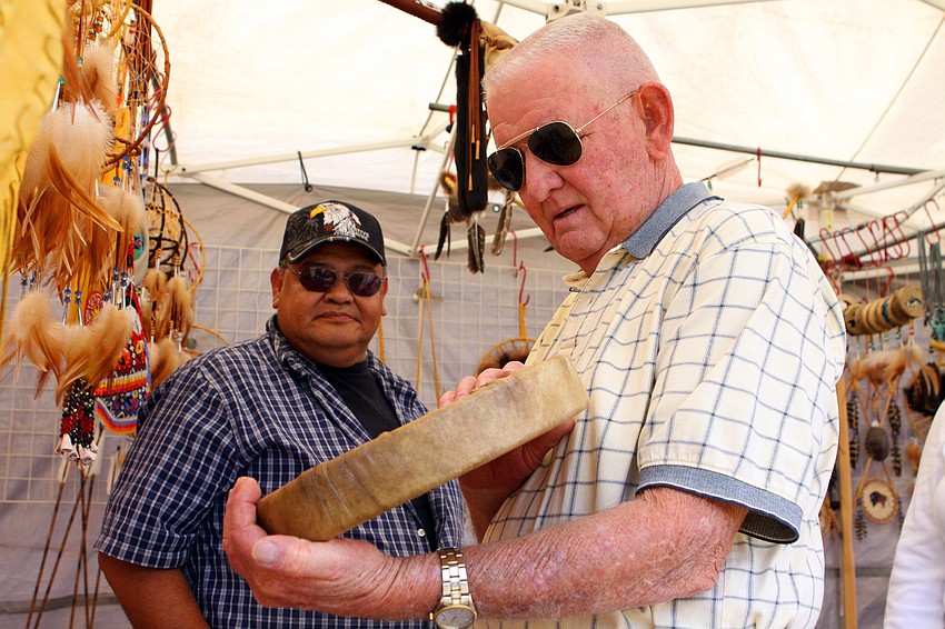 Harry Duran talks to Don Johnson about the elk hand drum he held in his hand.