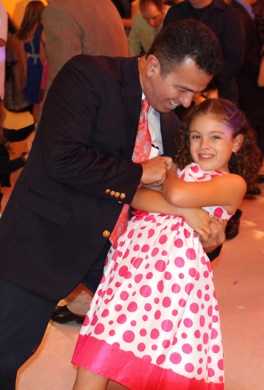 Felipe Cava dips his daughter, Sofia, 8, during the father-daughter dance, Friday, Feb. 3, at St. Marthaâ€™s.